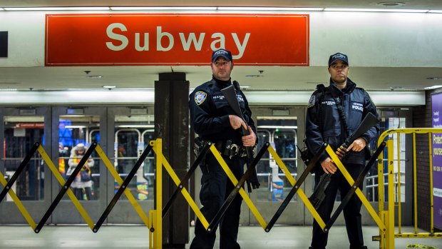 Police stand guard inside the Port Authority Terminal following.