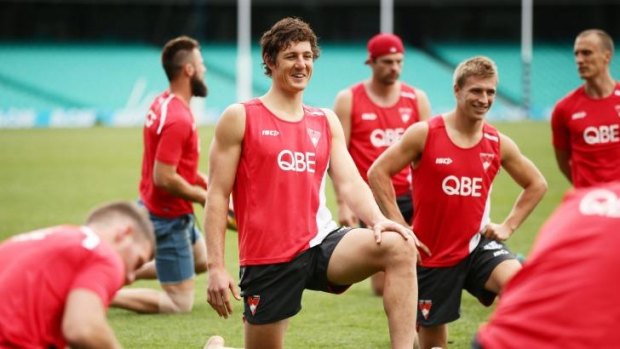 Bend, don't break: Kurt Tippett (centre) at a Swans recovery session.