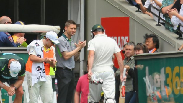 Dual roles: Michael Clarke applauds Shaun Marsh as he leaves the field after being dismissed on 99 in Melbourne.