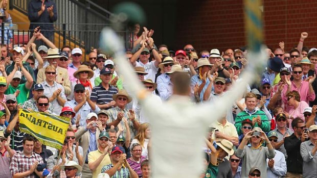The crowd applauds as Michael Clarke reaches his century.
