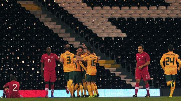 Australia players celebrate after forward Josh Kennedy scored in the opening minute.