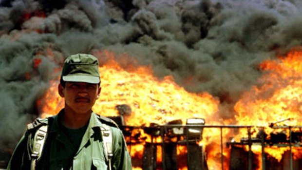 Cocaine trail ... a soldier stands guard as seized cocaine is burnt in Matamoros, Mexico.