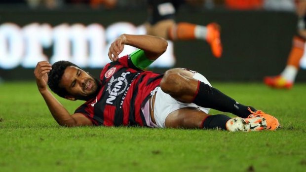 Wanderers centre-back Nikolai Topor-Stanley goes down injured during the A-League grand final.
