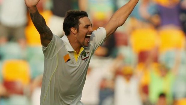 Mitchell Johnson of Australia celebrates after dismissing Jonathan Trott in the first Test of the Ashes series.