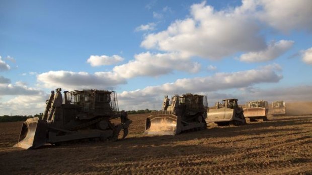 A convoy of Israeli armoured bulldozers move towards the Israeli-Gaza border.
