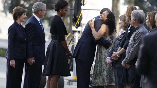 Ten years on ... President Barack Obama embraces a victim's relative as he visits the north pool of the World Trade Center site with first lady Michelle Obama, former President George W. Bush and former first lady Laura Bush.