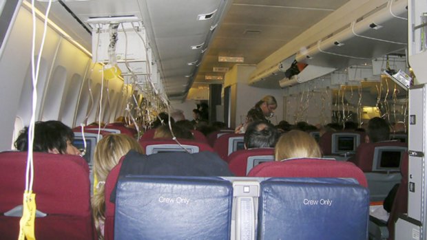 The scene inside the cabin of Qantas flight 30.
