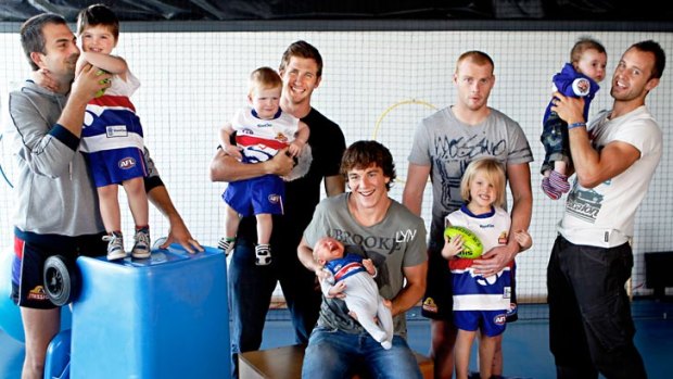 Western Bulldogs players with their young sons, from left, Brian Lake with three-year-old Cohen, Dale Morris with two-year-old Riley, Liam Picken with four-week-old Malachy, Adam Cooney with three-year-old Jaxon and Daniel Cross with 15-week-old Tyler.
