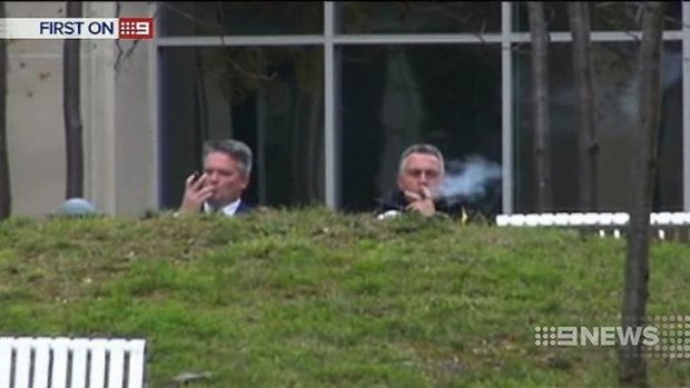 Finance Minister Mathias Cormann, left, and Treasurer Joe Hockey enjoy a cigar. 