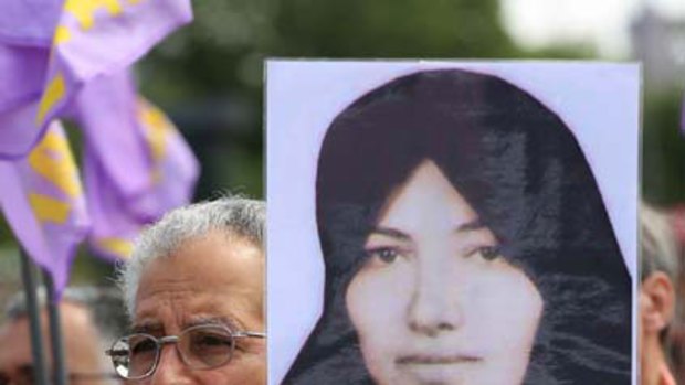 A protester holds a portrait of Sakineh Mohammadi Ashtiani. <i>Picture: Sean Gallup/Getty Images</i>