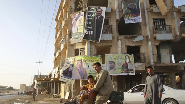 Election campaign posters cover a damaged building in Ramadi, about 100 km west of Baghdad.