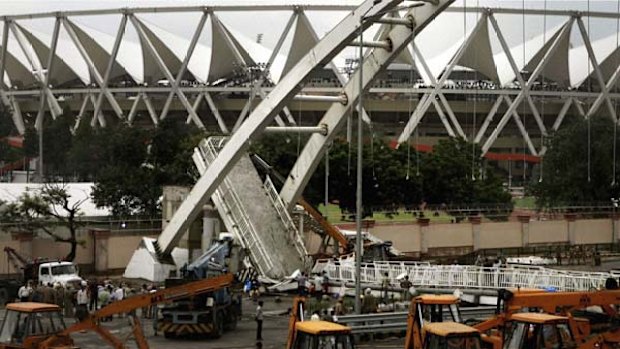 Cranes remove debris of the collapsed.