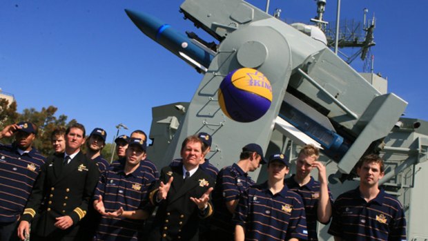 Sydney Kings players and Navy officers on board HMAS Sydney at the  team's 2006 season launch.