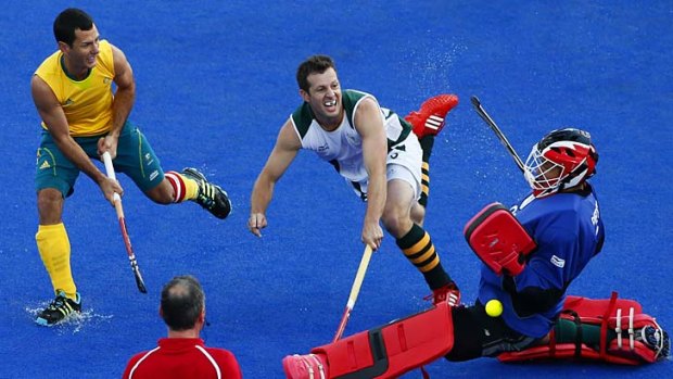 South Africa's goalkeeper Erasmus Pieterse makes a save against Australia's Jamie Dwyer.