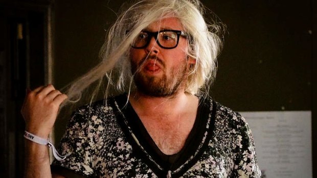 A bewigged and buck-tooth John Kearns.