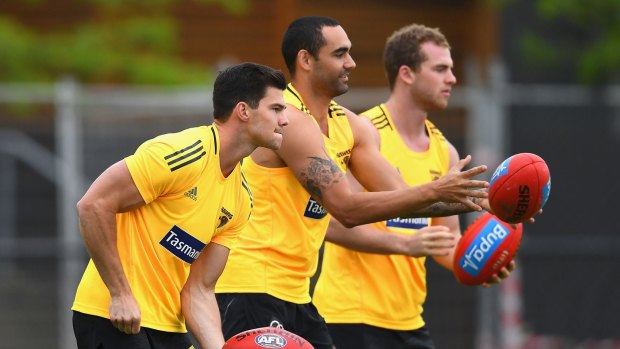 Mitchell, right, with Jaeger O'Meara and Shaun Burgoyn, centre, is "teaching blokes" at training, says Luke Hodge.