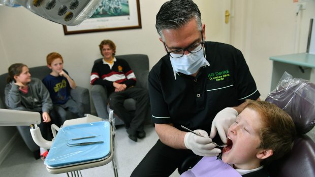 Dentist Andrew Gikas with the Grenville family