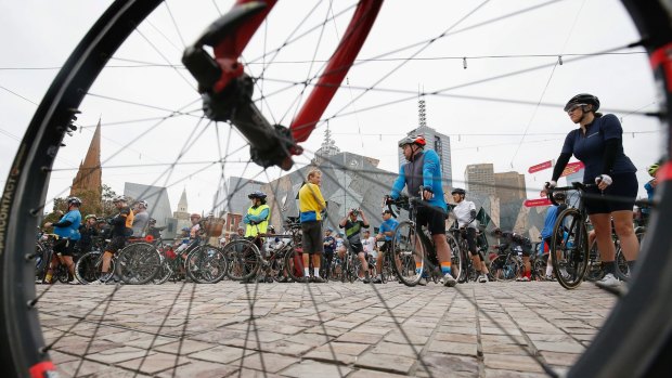 Hundreds of bicycle riders leave Federation Square for the Mike Hall tribute ride after he was killed near Canberra on the Indian Pacific Wheel Ride.