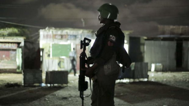 Peacekeepers: One of the Nigerian contingent to Amison, the Africa Union's force, supports Somali police on night patrol.