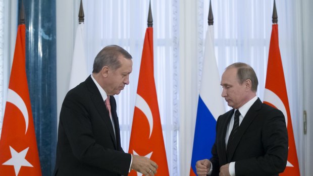 All good now? Russian President Vladimir Putin, right, and Turkish President Recep Tayyip Erdogan shake hands during a news conference.