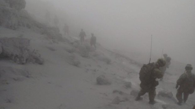 Japan Self-Defence Force  soldiers conduct rescue operations near the peak of Mount Ontake.