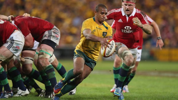 Will Genia of the Wallabies is tackled by Jamie Heaslip during the First Test match between the Australian Wallabies and the British & Irish Lions at Suncorp Stadium on June 22, 2013 in Brisbane, Australia.