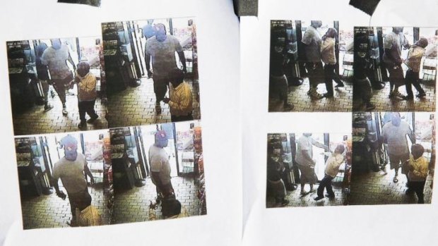 Security camera images released by Ferguson police of an alleged robbery of a convenience store. The suspect took cigars from the store. Officer Darren Wilson had stopped Michael Brown for questioning, according to police.