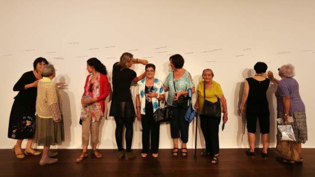 Members of a visiting cultural women's group line up to be measured in Measuring the Universe as part of Project 28: Roman Ondak at the Parramatta Town Hall.
