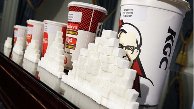 Various size cups and their equivalent in sugar cubes are displayed as part of New York City Hall's plans to crack down on the sale of large soft drinks.
