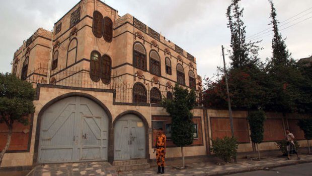 A Yemeni soldier stands guard in front of the Iranian embassy in Sanaa, as authorities tighten security measures.