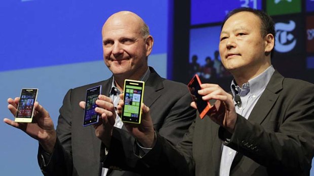 "Milestone" ... Microsoft CEO Steve Ballmer, left, and HTC CEO Peter Chou show off the new HTC Windows 8 phones.