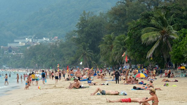 Foreign tourists relax at Patong beach in Phuket on Christmas Day.