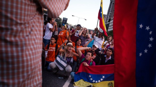 Protesters stage a sit-in as Venezuela lurched closer to a full-blown crisis on Friday.