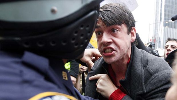 Anger ... a demonstrator yells at a New York City police officer.