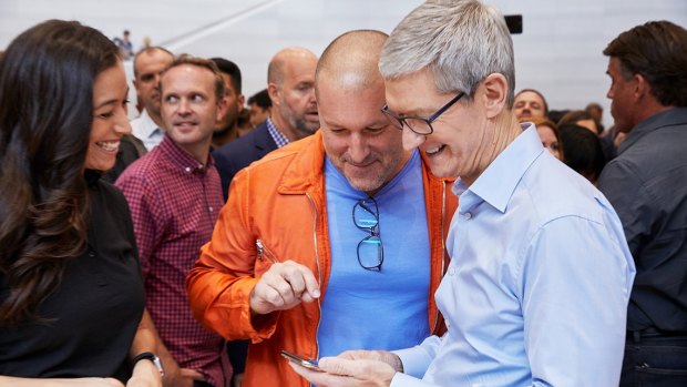 Apple's Tim Cook and Jony Ive look at the new iPhone X. Cook says he has put boundaries on his nephew using social media.