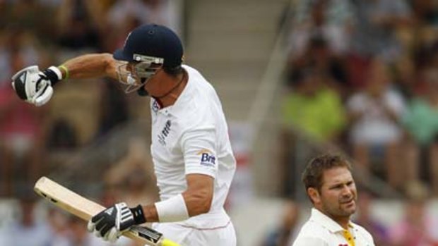England's Kevin Pietersen jumps for joy after bringing up his century, while Ryan Harris looks on.
