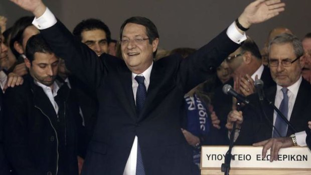 Triumph ... newly elected Cypriot President Nicos Anastasiades acknowledges supporters  in Nicosia on Sunday.