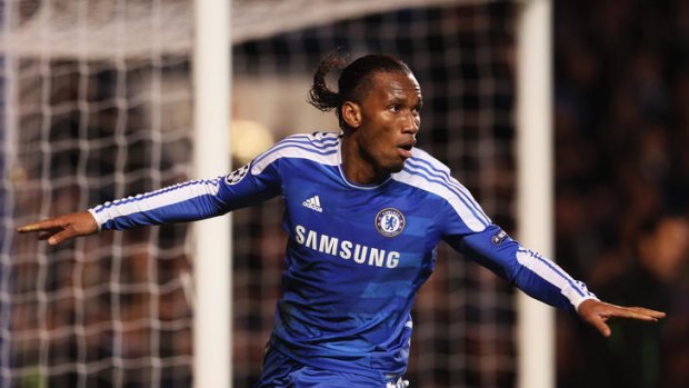 Flying high ... Didier Drogba of Chelsea celebrates his hat-trick of goals in the Champions League clash against Valencia.