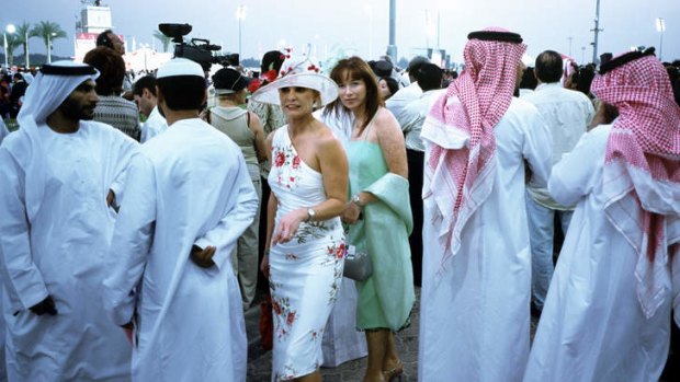 Two western women among Emirati men at Dubai races.