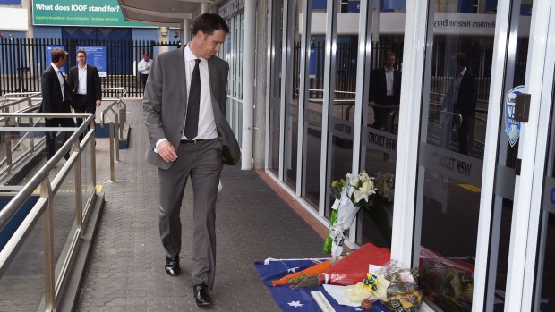 Testing times: Cricket Australia chief James Sutherland looks at tributes left at the Sydney Cricket Ground.