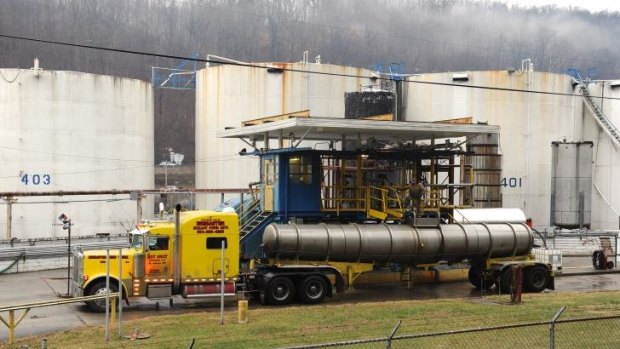Workers pump 4-methylcyclohexane methanol, a foaming agent used in the coal preparation process, out of a leaking tank at Freedom Industries, a chemical storage facility, in Charleston, West Virginia, on Friday.