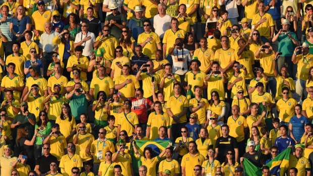 Agony and the ecstasy: Brazil fans turn the Itaquerao Stadium into a sea of yellow.