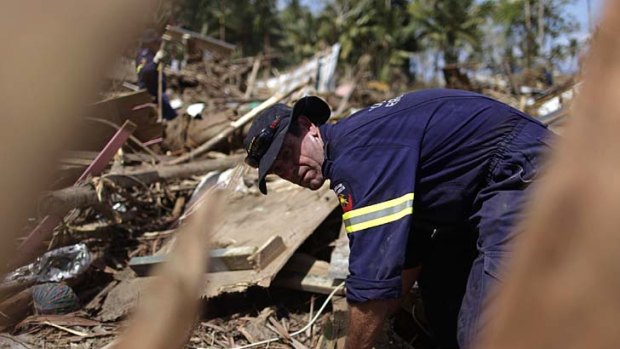 A Queensland Fire and Rescue Service emergency worker on the job in a disaster zone.
