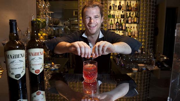 Shaun Byrne mixes up a cocktail at Bar Ampere in Russell Place. He has collaborated with French winemaker Gilles Lapulus to produce Maidenii Vermouth, using Australian native plants.