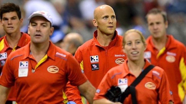 Out injured: Gold Coast's Gary Ablett (centre) at the match against North Melbourne last night.