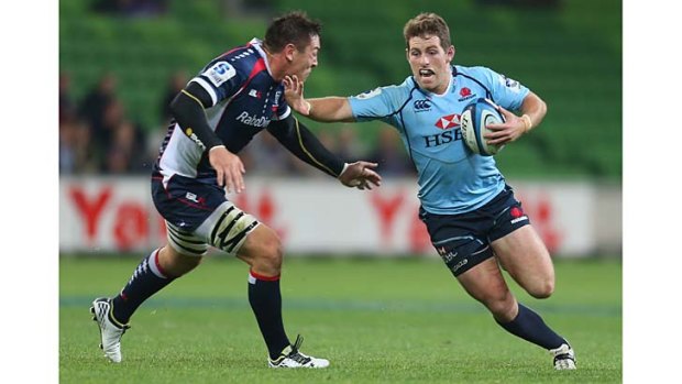 Bernard Foley of the Waratahs is tackled by Gareth Delve of the Rebels at AAMI Park on Friday night.