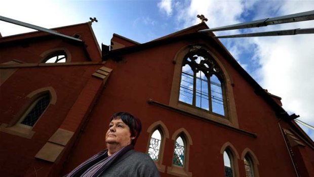 Save St Joseph's spokeswoman Mary Fenelon outside the propped-up shell of the church, gutted by fire in 2007, which she insists must be rebuilt.