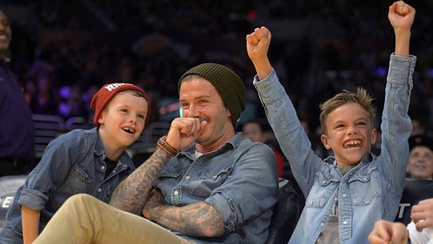 What's so funny? &#8230; David Beckham shares a laugh with sons Cruz and Romeo at a Los Angeles Lakers game on Friday.