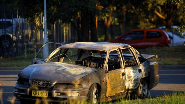 A burnt-out car on Benson Road, Ingleburn.