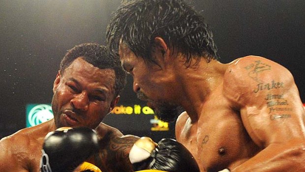 Manny Pacquiao of the Philippines lands a punch on Shane Mosley of the US.